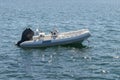 Inflatable motor boat at sea at anchor Royalty Free Stock Photo