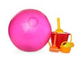 Inflatable pink beach ball and child plastic toys on white background Royalty Free Stock Photo