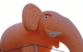 Inflatable pink elephant with white tusks against the blue sky tied ropes Royalty Free Stock Photo