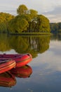 Inflatable red boats on water on the river or lake near the shore in a clear summer day