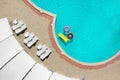 Inflatable rings and mattress floating in swimming pool. Summer vacation Royalty Free Stock Photo