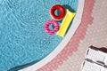 Inflatable rings and mattress floating in swimming pool. Summer vacation Royalty Free Stock Photo