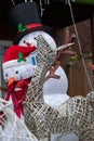 Inflatable snowmen with reindeer in foreground to celebrate Christmas, photographed in a suburban garden in Windsor UK.