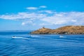 Inflatable speed boats cruising in mediterranean sea.  Lighthouse on a cape. Greece, Kea Tzia island Royalty Free Stock Photo
