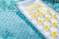 Inflatable swimming pool air mattress floating on clear swimming pool water Royalty Free Stock Photo