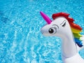 Inflatable toy white unicorn in the pool