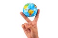 Inflatable world globe toy in hand making V sign.