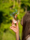 inflate big soap bubbles  girl inflates soap bubbles against the background Royalty Free Stock Photo