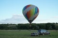 Inflating a balloon lying on the grass with burning air