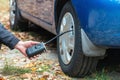 Inflating car tires with a portable wireless air pump outdoor