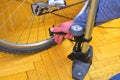 Inflating the tire of a bicycle. Cyclist repairs bike. Bicyclist pumping air into the wheel. Biker uses a bicycle pump Royalty Free Stock Photo