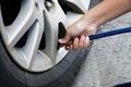 Inflating tire and checking air pressure in service station.Filling air into a car tire at service center Royalty Free Stock Photo