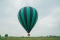 Inflating, unpack and flying up hot air balloon watermelon. Burner directing flame into envelope. Take off aircraft fly Royalty Free Stock Photo