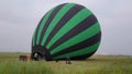 Inflating, unpack and flying up hot air balloon watermelon. Burner directing flame into envelope. Take off aircraft fly