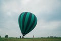 Inflating, unpack and flying up hot air balloon watermelon. Burner directing flame into envelope. Take off aircraft fly Royalty Free Stock Photo