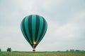 Inflating, unpack and flying up hot air balloon watermelon. Burner directing flame into envelope. Take off aircraft fly Royalty Free Stock Photo