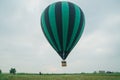 Inflating, unpack and flying up hot air balloon watermelon. Burner directing flame into envelope. Take off aircraft fly Royalty Free Stock Photo