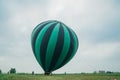 Inflating, unpack and flying up hot air balloon watermelon. Burner directing flame into envelope. Take off aircraft fly Royalty Free Stock Photo