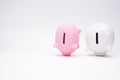 Inflation and devaluation concepts - Pink White Piggy Bank against white wall background