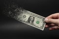 Inflation, dollar hyperinflation with black background. One dollar bill is sprayed in the hand of a man on a black