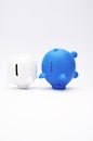 Inflation and devaluation concepts - Blue White Piggy Bank against white wall background