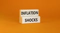 Inflation shocks symbol. Concept words Inflation shocks on wooden blocks. Beautiful orange table orange background. Business