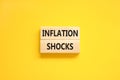 Inflation shocks symbol. Concept words Inflation shocks on wooden blocks. Beautiful yellow table yellow background. Business