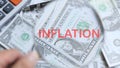 INFLATION word on a wooden cube on coins in idea for FED consider interest rate hike, world economics, and inflation control, US