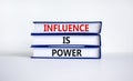 Influence is power symbol. Books with words `Influence is power`. Beautiful white background. Business, influence is power conce