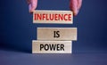 Influence is power symbol. Wooden blocks with words `Influence is power`. Beautiful grey background, businessman hand. Business,