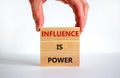 Influence is power symbol. Wooden blocks with words `Influence is power`. Beautiful white background, businessman hand. Business