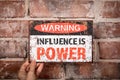 Influence is Power. Warning sign with text