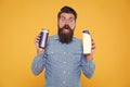 Influencer beauty blogger reviewing bath cosmetics. Bath soap. Bath cosmetics review. Man bearded hipster hold plastic