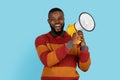 Info For You. Cheerful Black Man Making Announcement With Loudspeaker Royalty Free Stock Photo