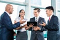 Informal business people with table computer discussing