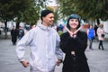 Informal girl with blue hair and a man with pale skin at the street walking