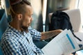 Informal guy studies working documents in a coworking space