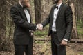 Handshake business partners in an informal meeting in nature Royalty Free Stock Photo