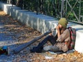 Informal street musician playing on Didgeridoo.