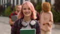 Informal student girl smiling schoolgirl female woman with pink hair smile invite welcome gesture walking with friends Royalty Free Stock Photo