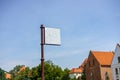 Information or advertisement blank sign board mounted in urban park outdoor. Metal Sign on street pole. Royalty Free Stock Photo