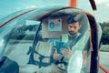 Attentive serious guy with black bearded sitting in the helicopter
