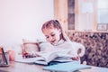 Elegant child finding information in book for homework