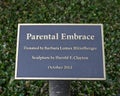 Information plaque for `Parental Embrace` by stone carver Harold F. Clayton in Hitzelberger Park, Dallas, Texas