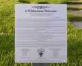 Information plaque and poem for `A Wilderness Welcome` by Archie Saint Clair in the historic district of Grapevine