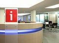 Information point in office building with red plastic sign i written on it Royalty Free Stock Photo