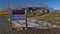 Information sign at Deildartunguhver hot springs in Reykholt in BorgarbyggÃÂ° in Iceland with steaming hot water in winter.