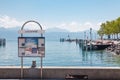 Information sign and timetable post at pier in Lausanne Ouchy port, Switzerland on Lake Leman, Geneva Lake Royalty Free Stock Photo