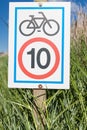 Information signboard about bicycle speed limitation Royalty Free Stock Photo