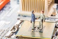 Information Technology security or IT success concept. Two miniature businessmen IT managers shaking hands while standing on CPU a Royalty Free Stock Photo